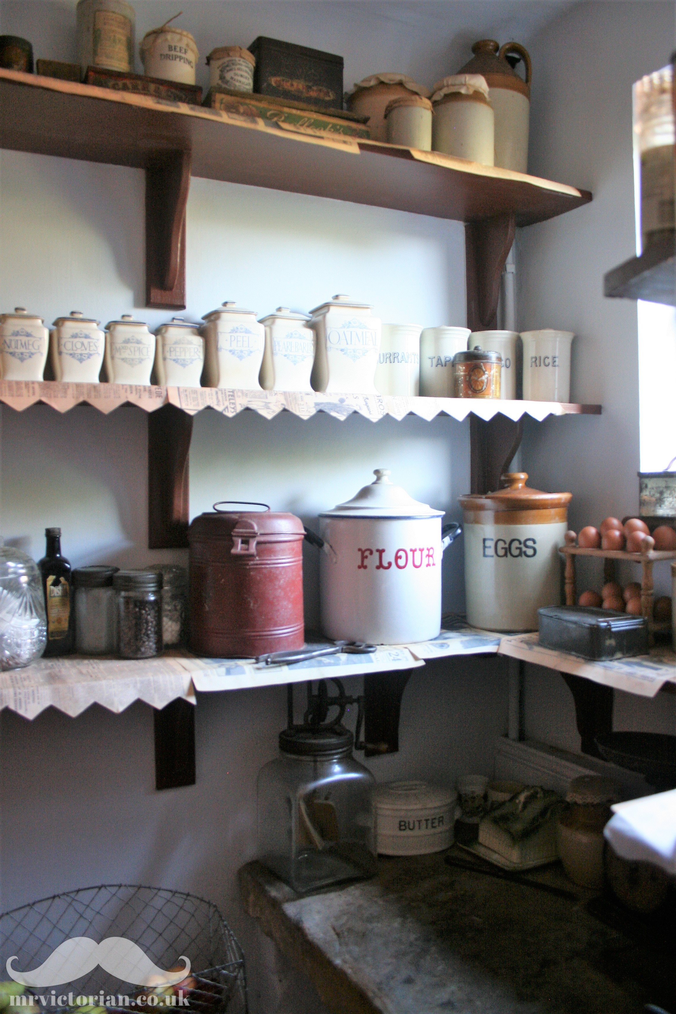 Victorian period organised pantry interior with old antique storage  stoneware jars