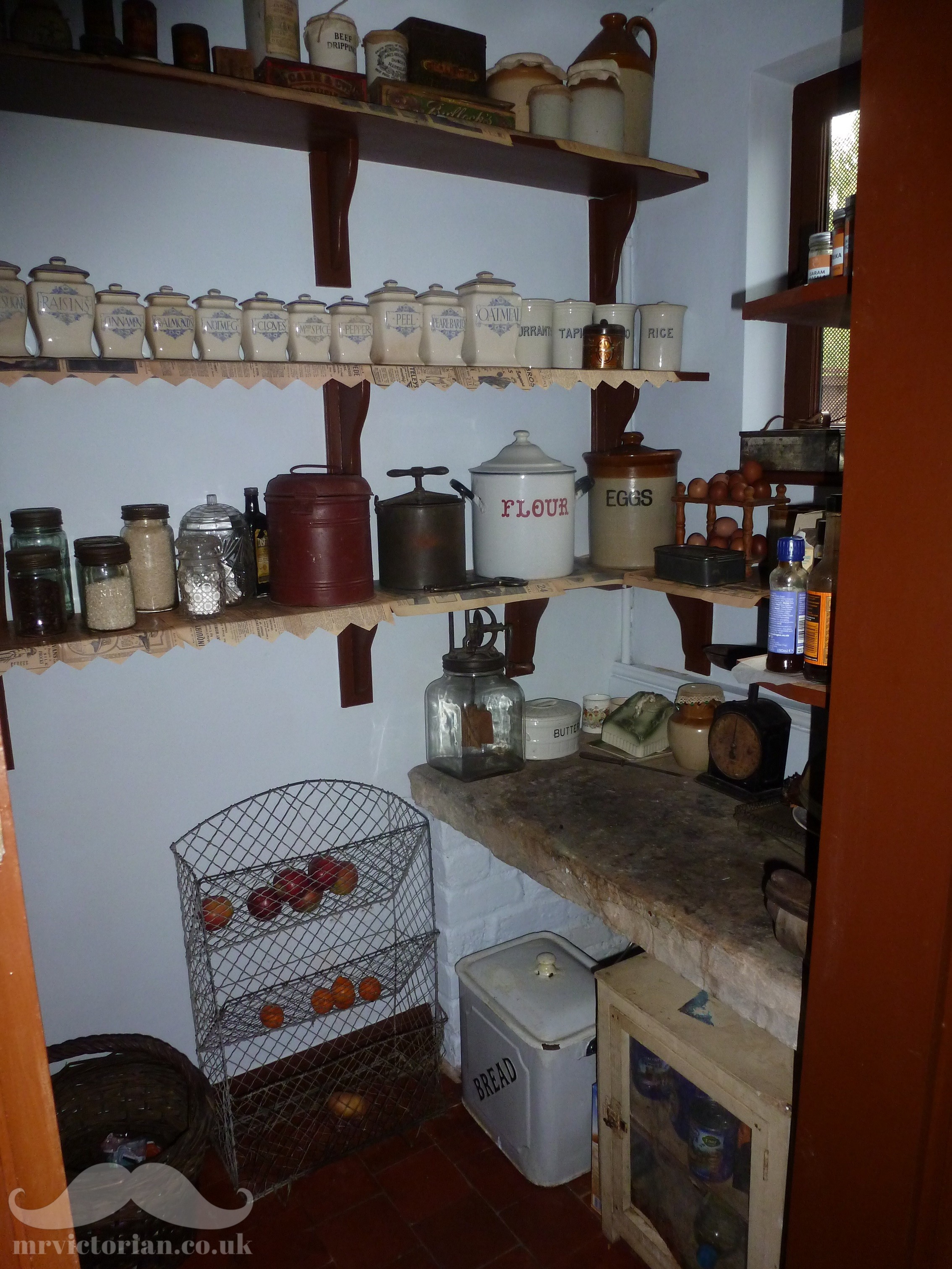 Victorian period organised pantry interior with old antique storage  stoneware jars