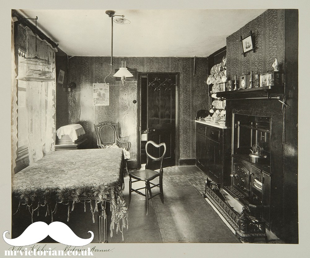 Victorian kitchen in middle class London home with wood panelled wallpaper.