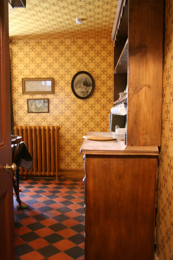 Modern conveniences - woodgrained radiator in my Victorian kitchen showing quarry tiled floor and dresser