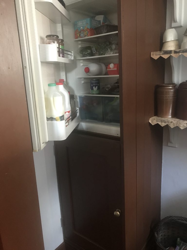Modern convenience - fridge freezer in Victorian period style cupboard with open door