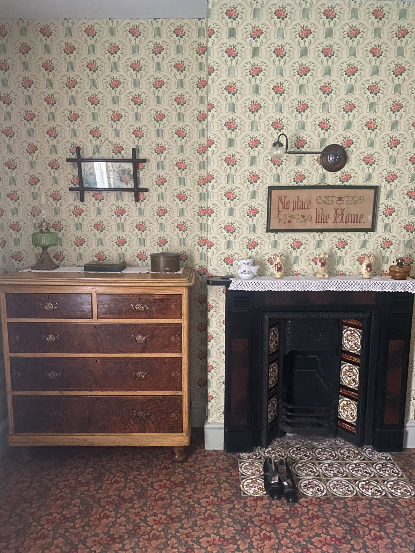 Victorian bedroom with 1905 recreated wallpaper and tiled fireplace