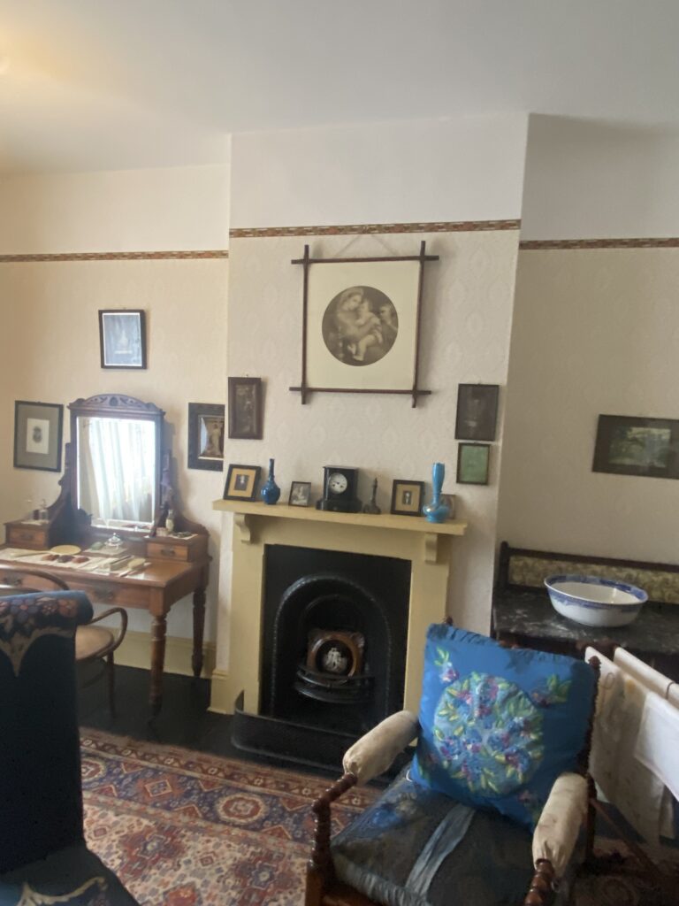 A bedroom with fireplace in typical Victorian interior style..