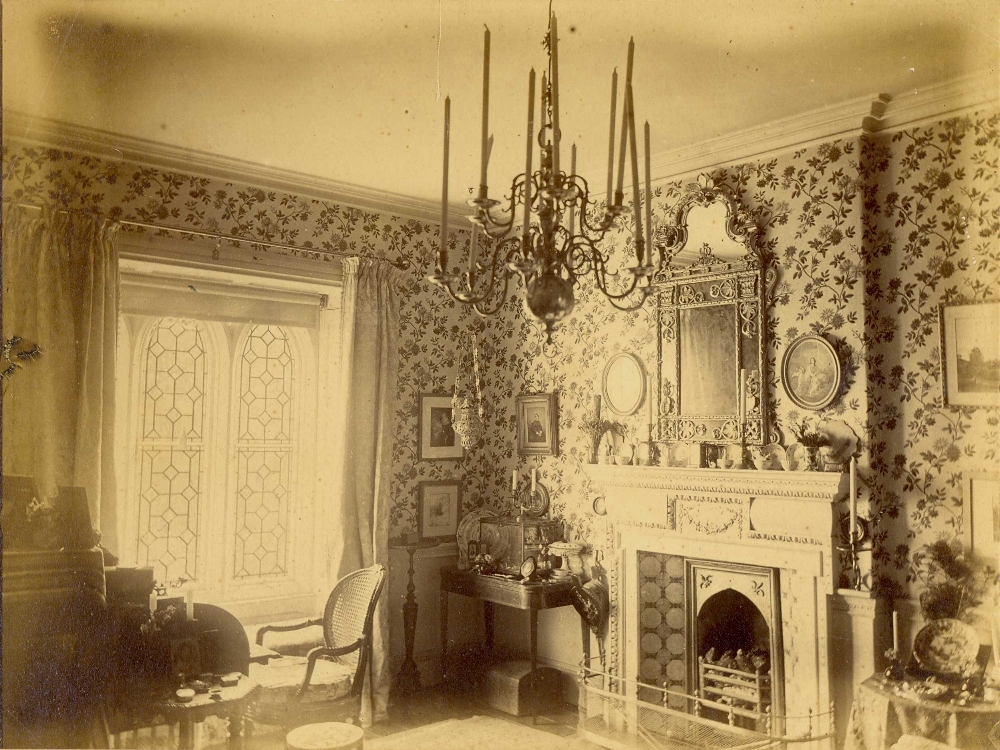 Victorian parlour with white painted woodwork and light floral wallpaper