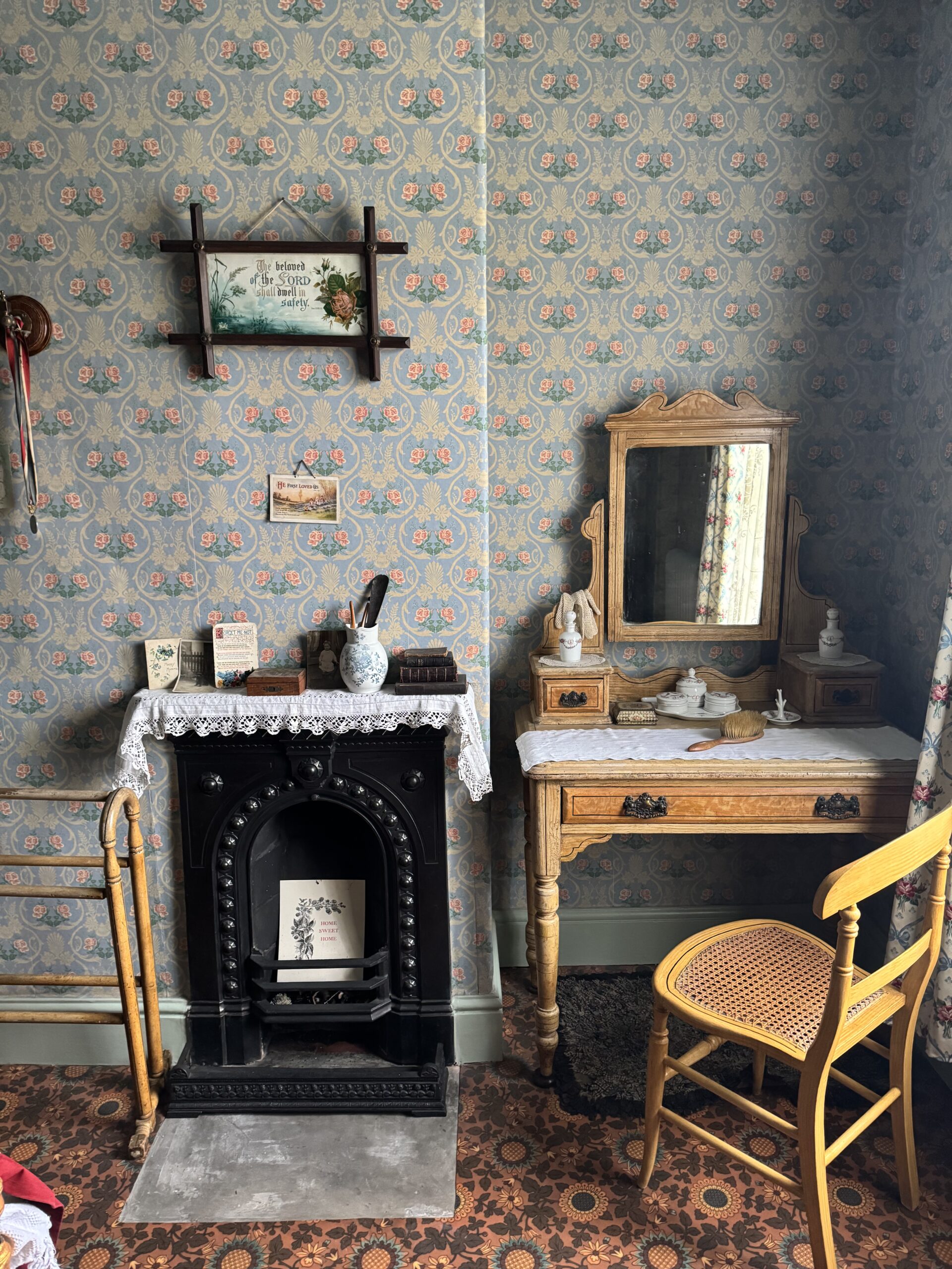 Victorian house tour - bedroom with fireplace and 1905 wallpaper, fireplace and dressing table